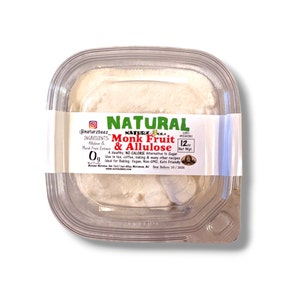 May include: A clear plastic container with a white powder inside. The label reads "NATURAL Monk Fruit & Allulose" with the ingredients listed as "Allulose & Monk Fruit Extract". The label also states "A Healthy, NO CALORIE Alternative to Sugar. Use in tea, coffee, baking & many other recipes. Ideal for baking, Vegan, Non-GMO, Keto Friendly."