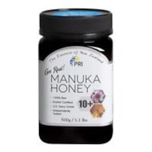 May include: A jar of Manuka honey with a black lid and a white label. The label includes the text "Get Real! Manuka Honey" and "10+". The jar contains 1.1 lbs (500g) of honey.