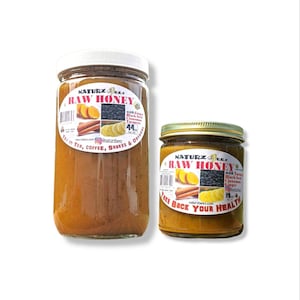 May include: Two glass jars of raw honey with a label that reads "Naturz Beez Raw Honey" with ingredients listed as "with Ginger, Black Seed, Cinnamon, Turmeric, Ginger". The larger jar is 44 oz and the smaller jar is 12 oz. The jars are on a white background.