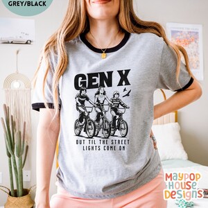 next level ribbed shirt for gen x woman that has three 70s or 80s era kids on bikes and text says gen x out til the street lights come on