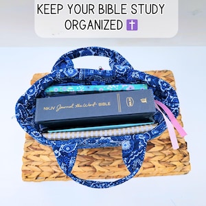 May include: A blue paisley tote bag filled with a Bible, notebooks, and pens, resting on a woven basket. The text "KEEP YOUR BIBLE STUDY ORGANIZED" is at the top.