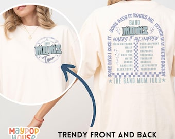 May include: A white t-shirt with a blue and white graphic on the front that says "Band Moms Tour". The back of the shirt has a blue and white graphic that says "Some days I rock it. Some days it rocks me. Band Moms Makes it all happen. The Band Mom Tour."
