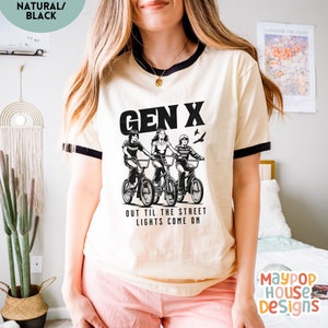 next level ribbed shirt for gen x woman that has three 70s or 80s era kids on bikes and text says gen x out til the street lights come on