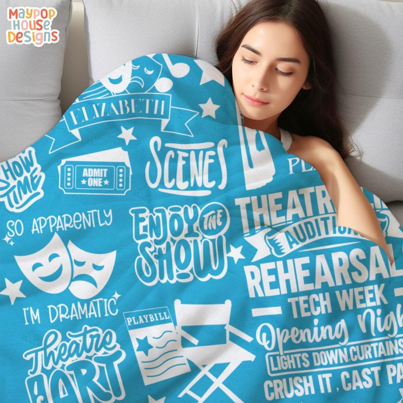 velveteen plush blanket for theater kid drama teacher actor that has a collage of different theater related words clipart and phrases and personalized with name
