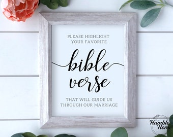 May include: A white framed sign with black text that reads "PLEASE HIGHLIGHT YOUR FAVORITE bible verse THAT WILL GUIDE US THROUGH OUR MARRIAGE".