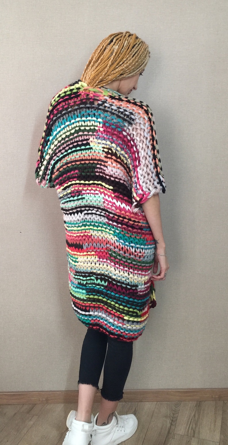May include: A colourful striped crochet cardigan with a loose fit and short sleeves.