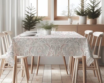 May include: A dining table set for a meal, featuring a patterned tablecloth in shades of gray, red, and white. The table is surrounded by wooden chairs and set near a window. Decorative potted plants and small Christmas trees add to the ambiance.
