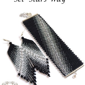 May include: A set of black and silver beaded jewelry with a bracelet and earrings. The bracelet has a silver clasp and the earrings are long and dangle. The set is called "Stars Way".