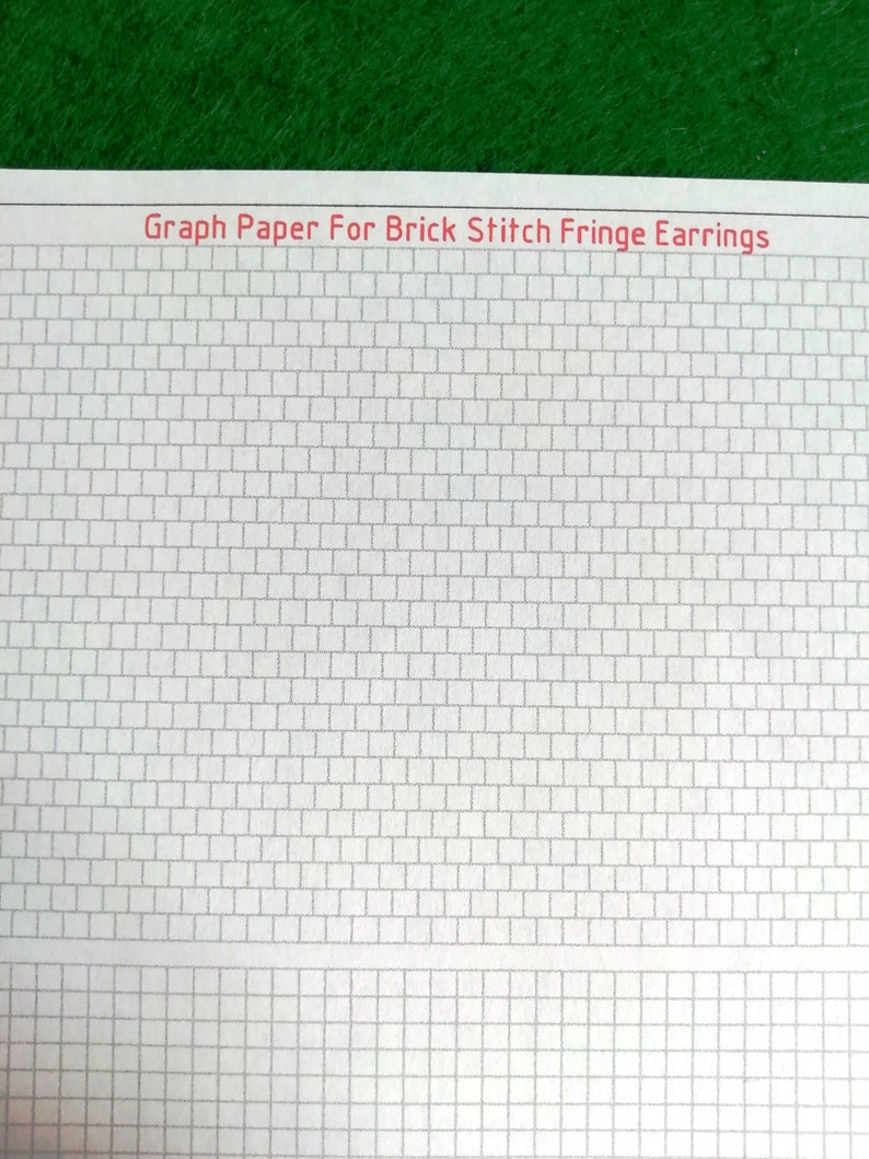 May include: A sheet of white graph paper featuring a grid of rectangular cells designed for brick stitch fringe earrings. The top of the page displays the red printed text Graph Paper For Brick Stitch Fringe Earrings in a sans-serif font.