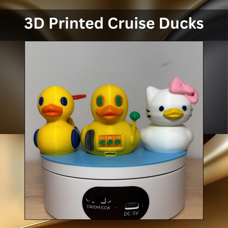 Three 3D printed figures labeled 3D Printed Cruise Ducks. The left is a yellow duck with blue wings. The center is a yellow duck with slot machine features and dollar sign eyes. The right is a white cat figure with a pink bow.