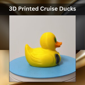 A yellow 3D printed duck figurine with an orange beak, green eyes, and a grey oval detail on its side. The text 3D Printed Cruise Ducks is displayed above the object, which is positioned on a flat, circular blue surface.