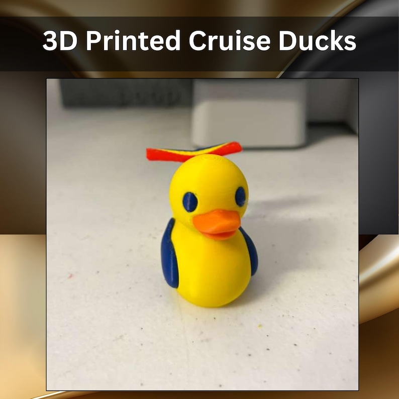 May include: A small 3D printed duck figurine featuring a yellow body, blue wings, and blue eyes. The duck has an orange beak and a red, yellow, and blue propeller hat on its head. The text 3D Printed Cruise Ducks is visible above.