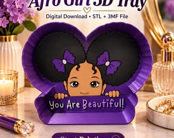 May include: A purple 3D printed tray featuring a cartoon character with two black afro puffs and purple bows. The character is peeking over a ledge with the text "You Are Beautiful!" printed on the front. The tray is heart-shaped.