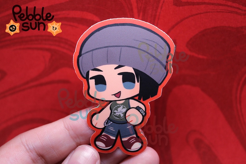 May include: A sticker featuring a cartoon character with a gray beanie, black hair, and blue eyes. The character wears a green tank top, blue shorts, and maroon shoes. The sticker has a red border and the text "Pebble Sun" is in the upper left corner.