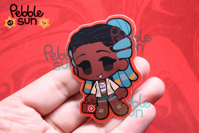 May include: A sticker featuring a cartoon character with dark skin, black hair, and blue highlights. The character wears a white jacket, shorts, and brown boots, holding a red first aid kit. The sticker has a red border and the text "Pebble Sun".