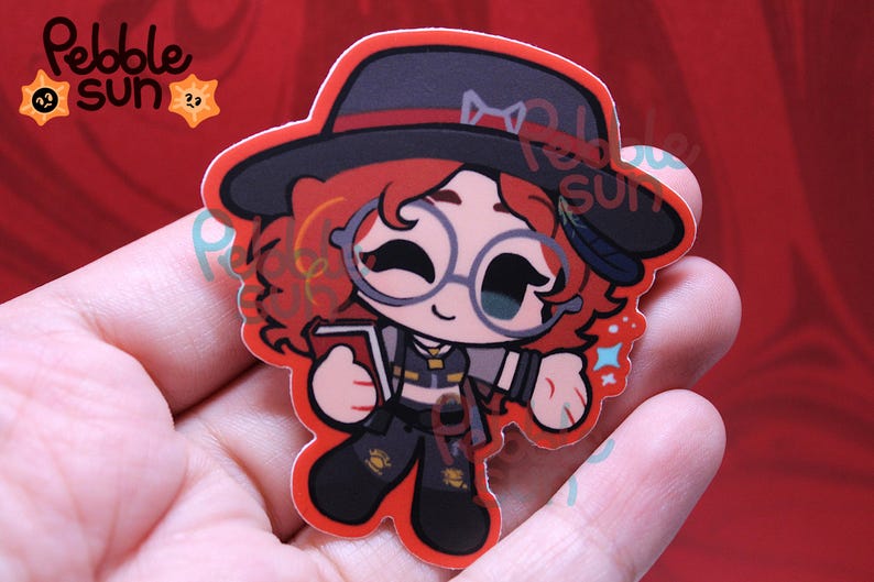 May include: A sticker featuring a cartoon character with red curly hair, round glasses, and a black hat. The character is holding a book and wearing a dark outfit. The sticker has a red border and the text "Pebble Sun" is visible.