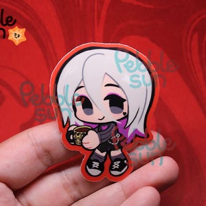 May include: A sticker featuring a cartoon character with white hair and purple highlights, holding a coffee mug. The character is wearing a black outfit with a heart detail. The sticker has a red border and the text "Pebble Sun".