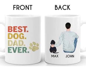 May include: White ceramic coffee mug with the text "BEST. DOG. DAD. EVER." in a retro font with a paw print. The back of the mug features a cartoon illustration of a man with a dog sitting next to him. The text "MAX" and "JOHN" are printed below the illustration.