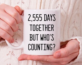 May include: White ceramic mug with black text that reads "2,555 days together but who's counting?"