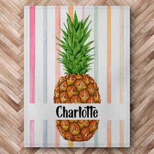 May include: A white background with colorful stripes and a watercolor pineapple with the name Charlotte written below it.