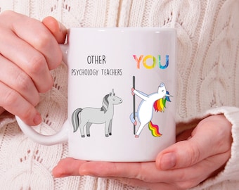 May include: White ceramic mug with a humorous design featuring two unicorns. The text reads "Other Psychology Teachers" and "You". The unicorn representing "You" is in a rainbow-colored pose, while the other unicorn is in a neutral pose.