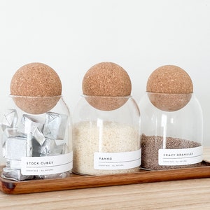 3 glass jar with cork ball lids and wooden tray