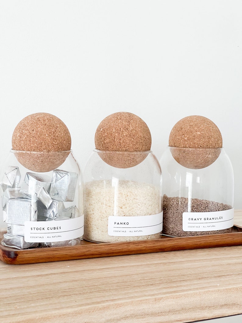 3 glass jar with cork ball lids and wooden tray