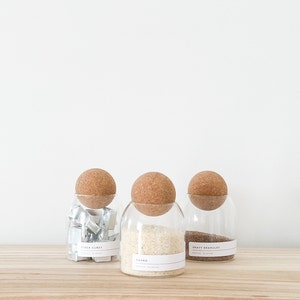 3 glass jar with cork ball lids and wooden tray