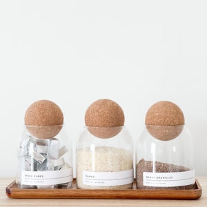 3 glass jar with cork ball lids and wooden tray