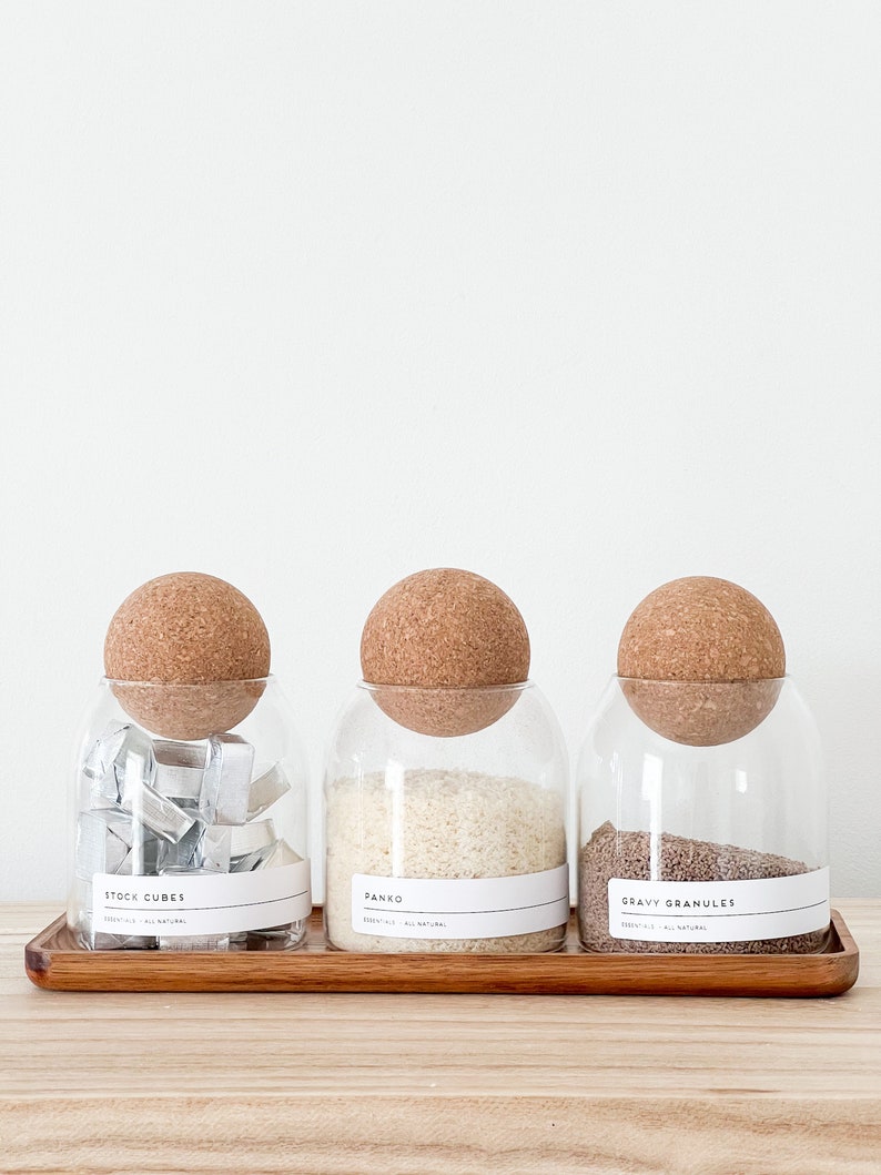3 glass jar with cork ball lids and wooden tray