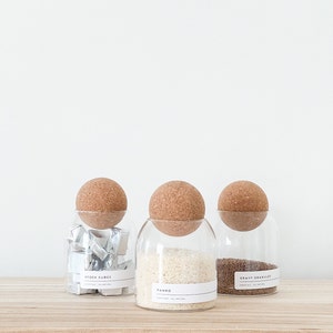 3 glass jar with cork ball lids and wooden tray