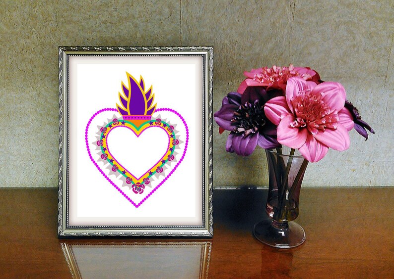 May include: A framed print of a colorful heart with a flame on top. The heart is surrounded by a pink, green, and yellow beaded border with small pink roses. The background is white.