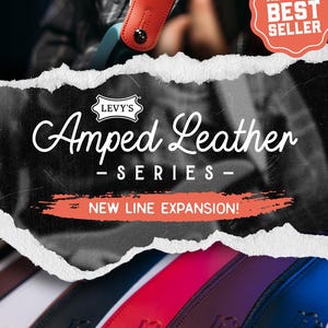 May include: A selection of leather guitar straps in various colors, including red, black, and blue. The straps are branded with the "Levy's" logo and the text "Amped Leather Series - New Line Expansion!" is displayed. A red strap is shown in use.