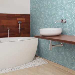 May include: A white bathtub with a blue and white patterned wallpaper behind it. A white porcelain sink is mounted on a wooden shelf above the bathtub. The sink has a chrome faucet.