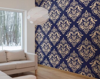 May include: A living room with a large window, a white lamp, and a beige couch. The wall is covered in blue and gold damask wallpaper.