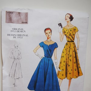May include: Vintage Vogue sewing pattern for a dress with a V-neckline and a full skirt. The pattern is from 1953 and is labelled "Original 1953 Design". The pattern is shown on two models, one wearing a blue dress and the other wearing a yellow dress with a floral print.