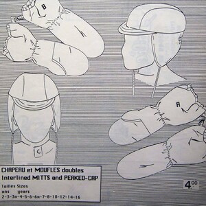 May include: A Jalie sewing pattern envelope 2949-AB featuring black line drawings of a peaked cap and mittens on a white background with horizontal lines. The text includes Jalie, PATRON, PATTERN, and CHAPEAU et MOUFLES doubles Interlined MITTS and PEAKED-CAP.