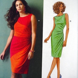 May include: A white ceramic mug with a black handle and the text "But First, Coffee" in a bold, black font. The mug is set against a blurred background, suggesting a cozy setting. The mug appears to be approximately 4 inches tall.