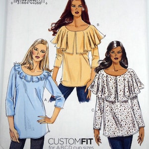 May include: Vogue pattern V8745 features three blouse designs with ruffled and custom-fit options. The pattern includes sizes Lrg-Xlg-XXL. The image shows illustrations of the blouses in blue, yellow, and white with a printed design.