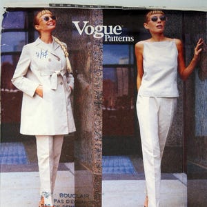 Puede incluir: Patrón de costura Vogue Patterns con un diseño de Michael Kors. La imagen muestra dos conjuntos: un conjunto de abrigo y pantalón color crema, y un conjunto de top y pantalón a juego. El logotipo de Vogue y el número de patrón 1918 son visibles.