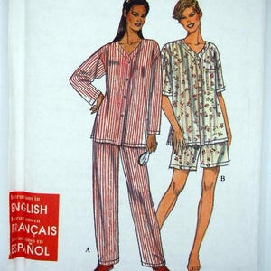 May include: A sewing pattern package with the text "It's SO EASY it's Simplicity". The package features illustrations of two pajama sets: one with long pants and a striped top, and another with shorts and a floral top.