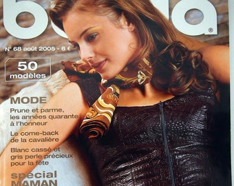 May include: A fashion magazine cover featuring a woman wearing a brown leather-like top with a zipper. The cover includes text in French, such as "TENDANCES MODE" and "Le charme du parme."
