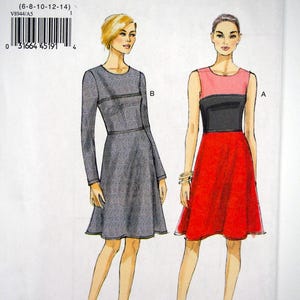 May include: A sewing pattern package labeled "V8944" with the text "VERY EASY VOGUE". The package features illustrations of two dresses: a gray long-sleeved dress and a red and black sleeveless dress. The size range is (6-8-10-12-14).