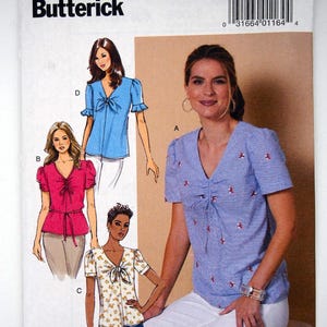 May include: Butterick sewing pattern B6662 for a V-neck top with short sleeves and a front tie closure. The envelope displays four variations of the top in blue, pink, white floral, and blue pinstripe with red embroidery, including a barcode and size AX5.