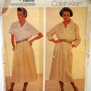 May include: Vogue Patterns American Designer Calvin Klein sewing pattern for a dress and skirt. The pattern number is 1320.