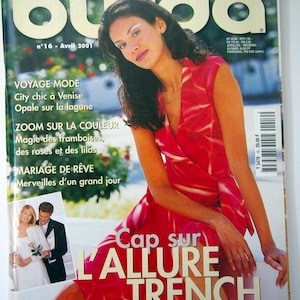 May include: A fashion magazine cover with a woman in a red dress. The magazine is titled "burda" with the words "TENDANCES MODE" above. The cover also features the text "Cap sur L'ALLURE TRENCH" and other French text.
