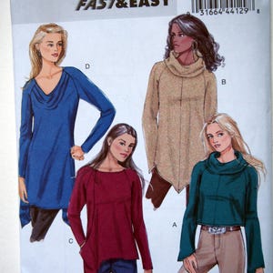 May include: A sewing pattern for three different tops. The pattern is called Butterick FAST & EASY B5679 and is for sizes Large, Extra Large, and Extra Extra Large. The tops are all long-sleeved and have a cowl neck. The first top is blue, the second is burgundy, and the third is teal.