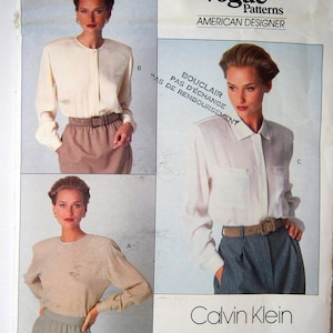 May include: Vogue Patterns American Designer sewing pattern for a blouse by Calvin Klein. The pattern number is 2397. The pattern is rated Very Easy/Très Facile. The pattern includes three different views of the blouse.
