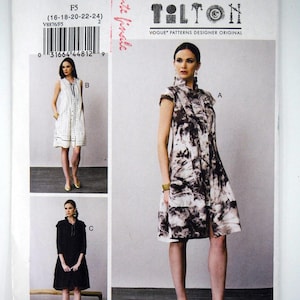 May include: Vogue Patterns V8876 sewing pattern envelope featuring Marci Tilton designs. The front displays three dress variations: a sleeveless white dress with vertical stripes, a black dress, and a short-sleeved dress with a dark abstract print.