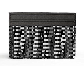 May include: Black leather card holder with a geometric pattern in shades of gray and white.